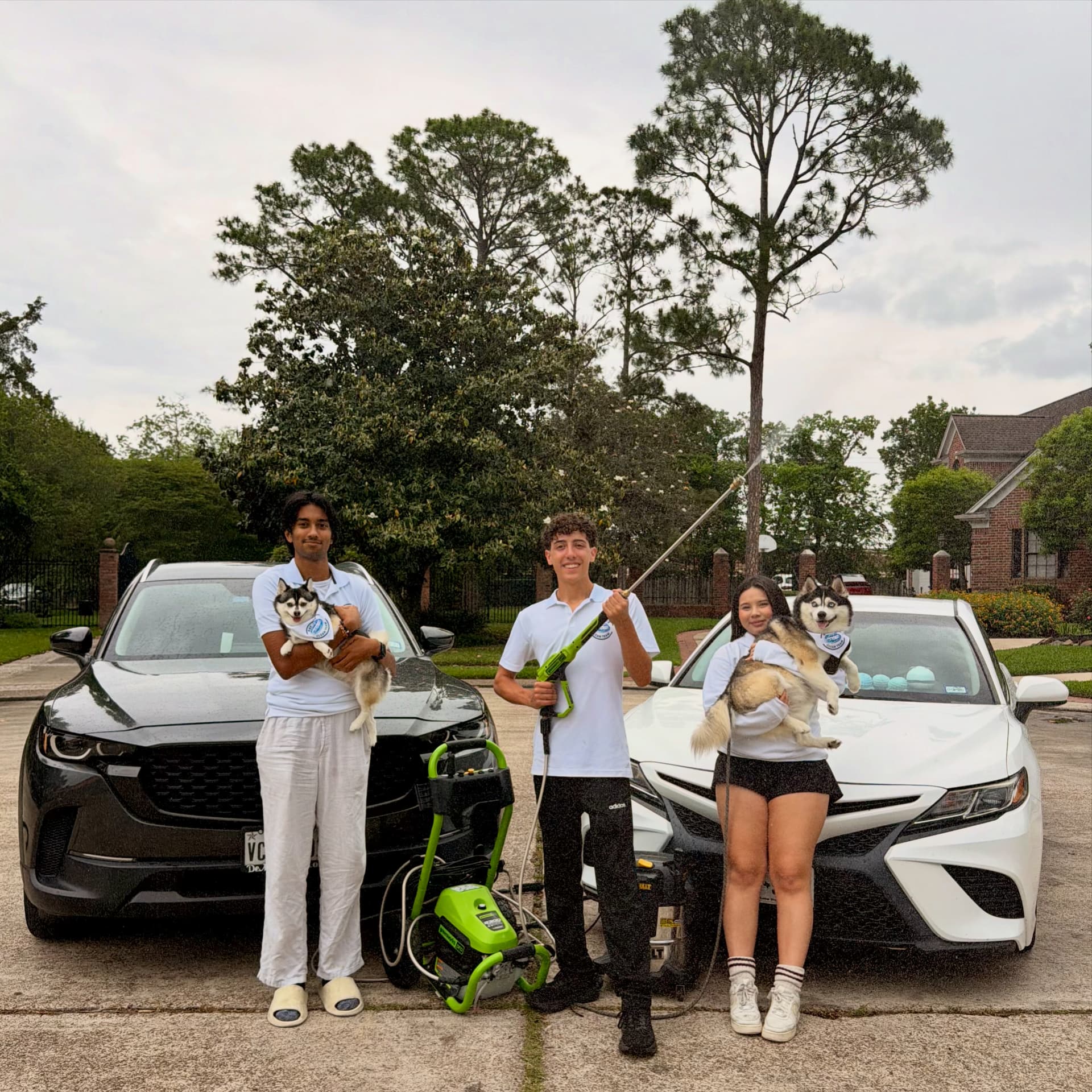 The Bay Area Clean Team crew beside two freshly cleaned cars