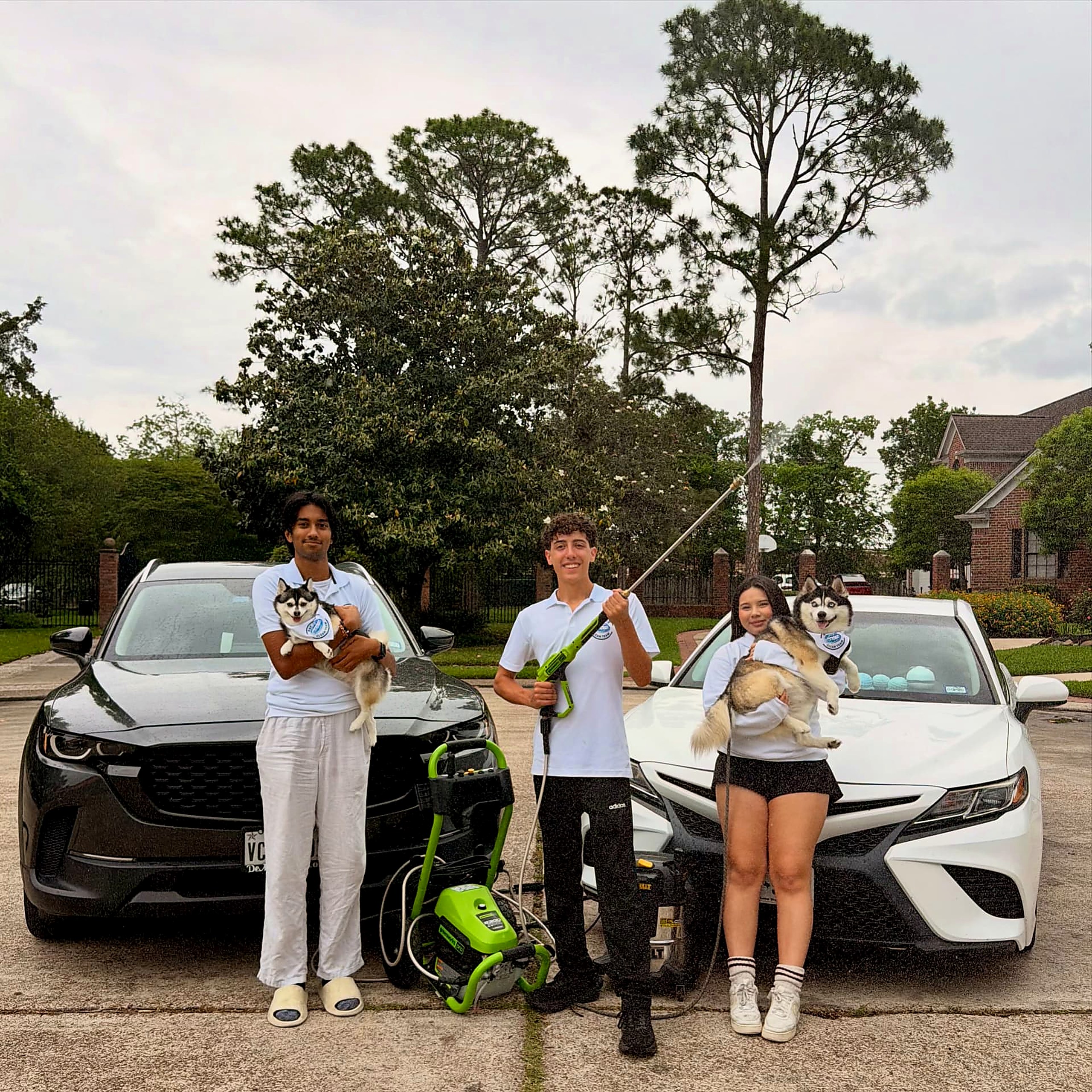 The Bay Area Clean Team crew beside two freshly cleaned cars