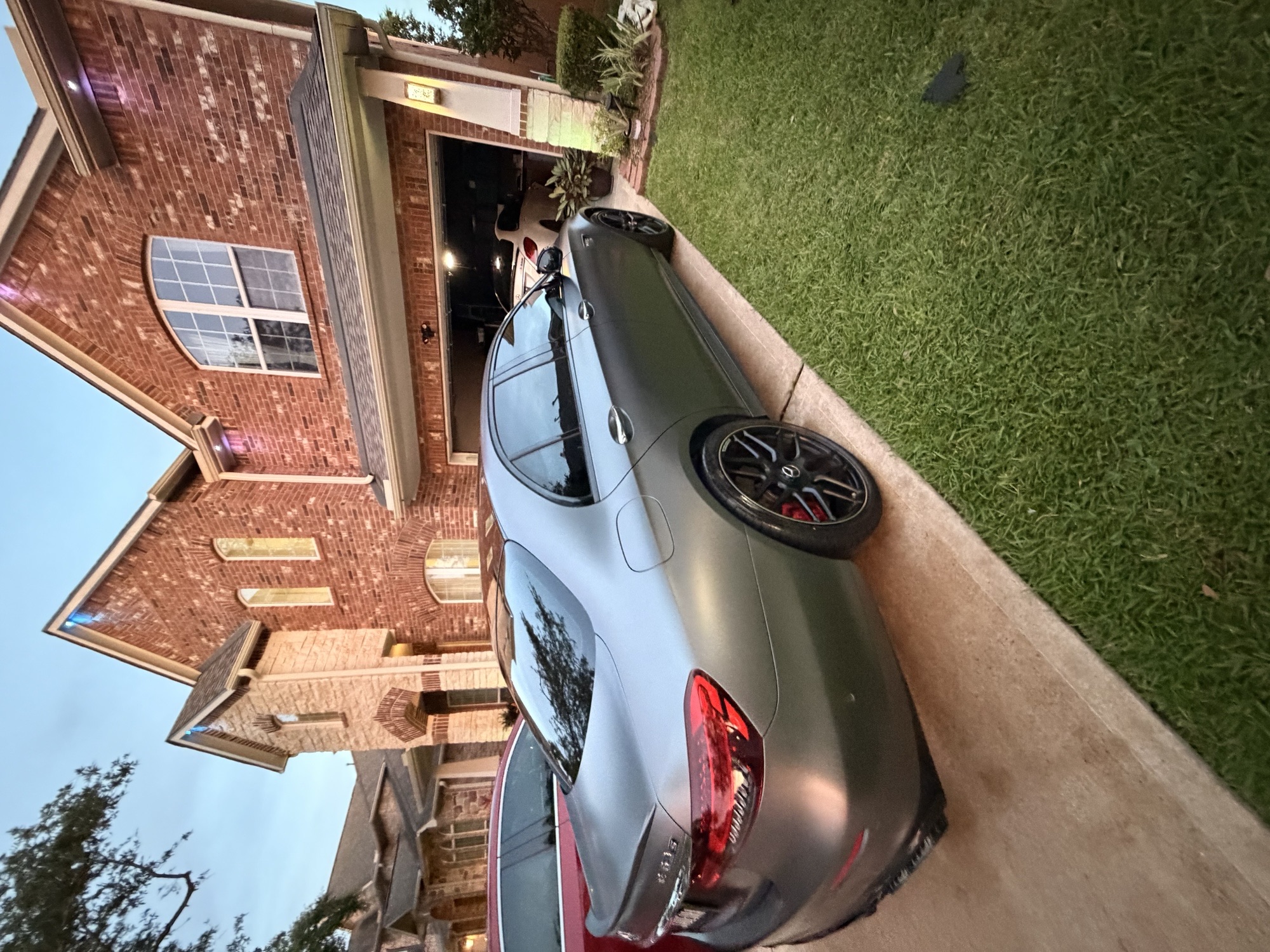 Matte grey Mercedes-AMG E63 S cleaned in a residential driveway